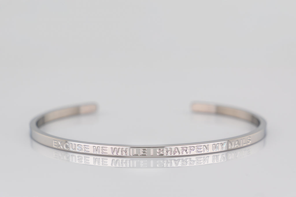 "EXCUSE ME WHILE I SHARPEN MY NAILS" cuff bracelet