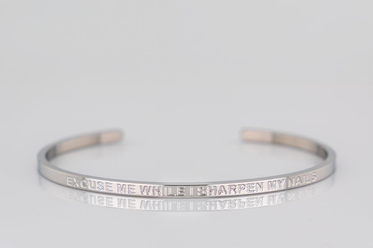 "EXCUSE ME WHILE I SHARPEN MY NAILS" cuff bracelet