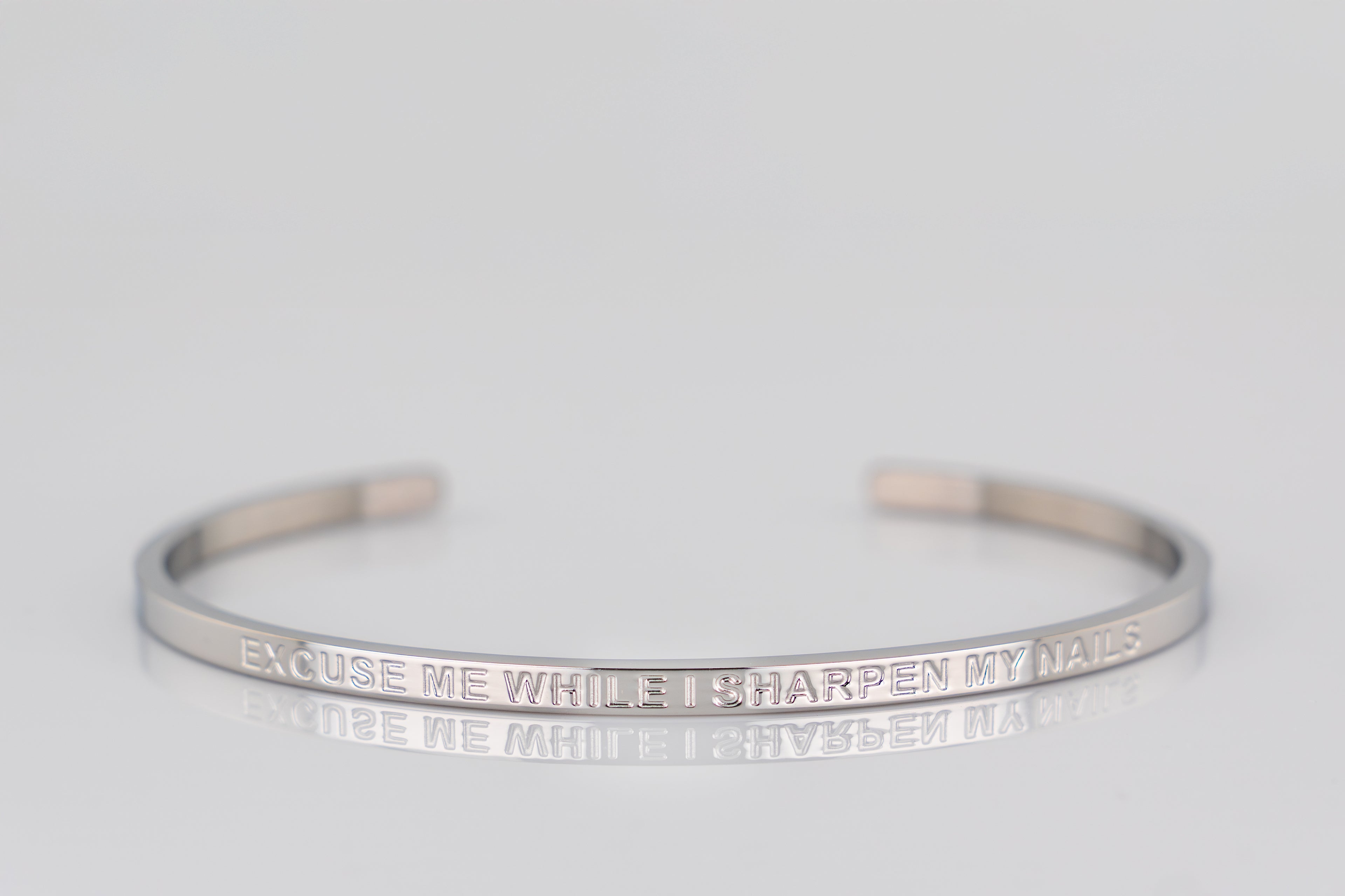 "EXCUSE ME WHILE I SHARPEN MY NAILS" cuff bracelet