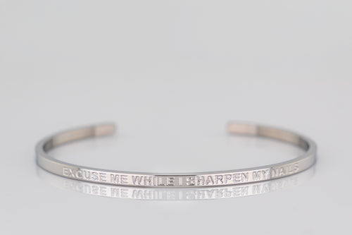 "EXCUSE ME WHILE I SHARPEN MY NAILS" cuff bracelet