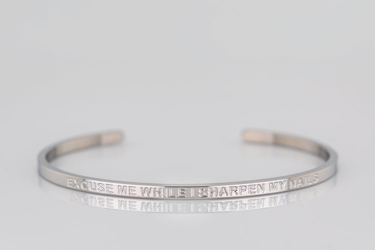 "EXCUSE ME WHILE I SHARPEN MY NAILS" cuff bracelet